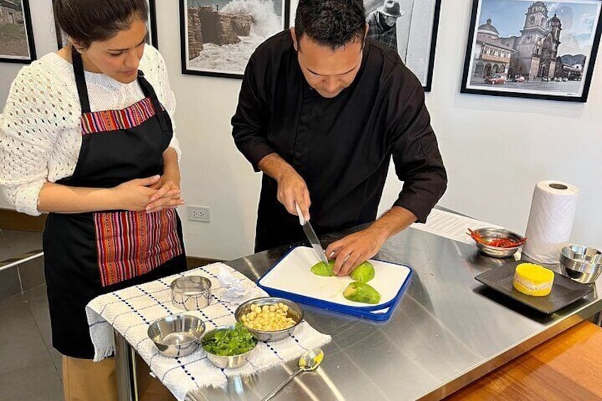 Our chef teaching how to make an avocado heart to decorate a traditional causa