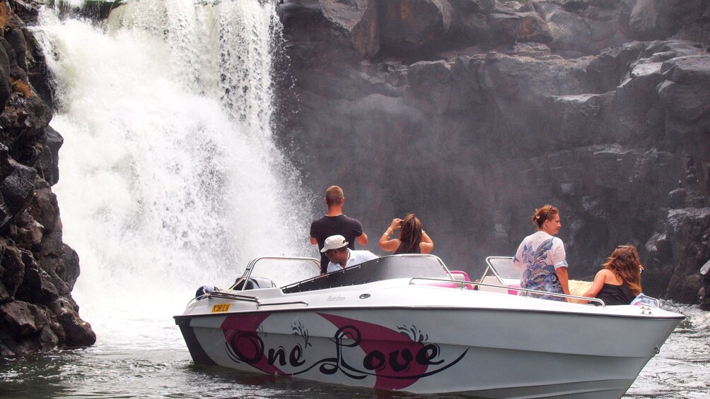 Tour speedboat near waterfall in Mauritius