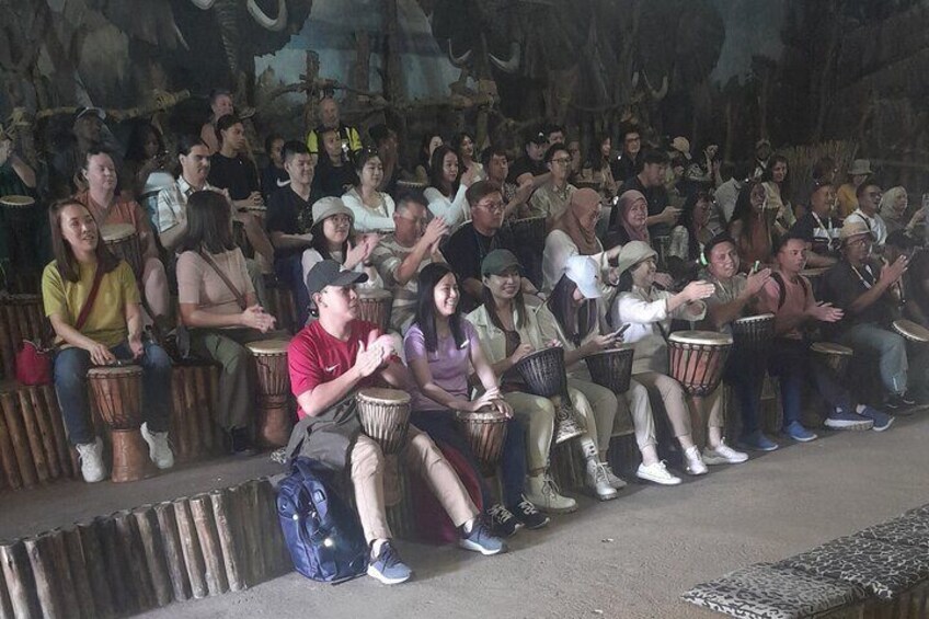 Teaching tourists how to play local drums at Lesedi cultural village