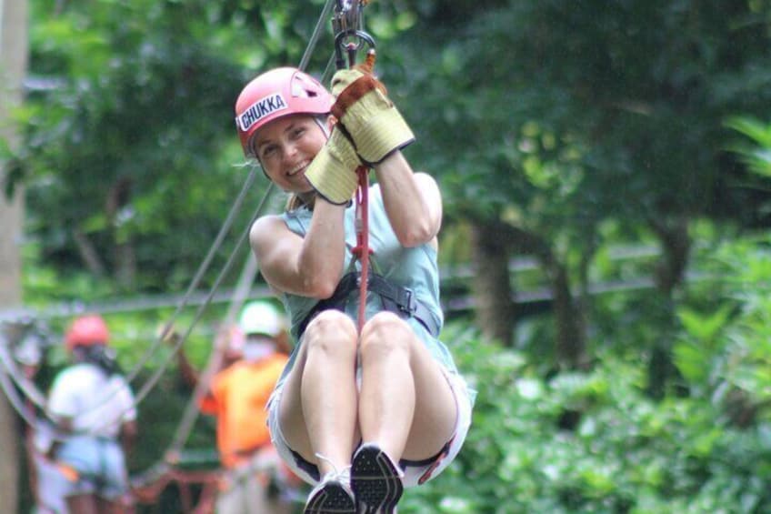 Mom ziplining from platform to platform at the Harrison's Cave Eco-Adventure Park