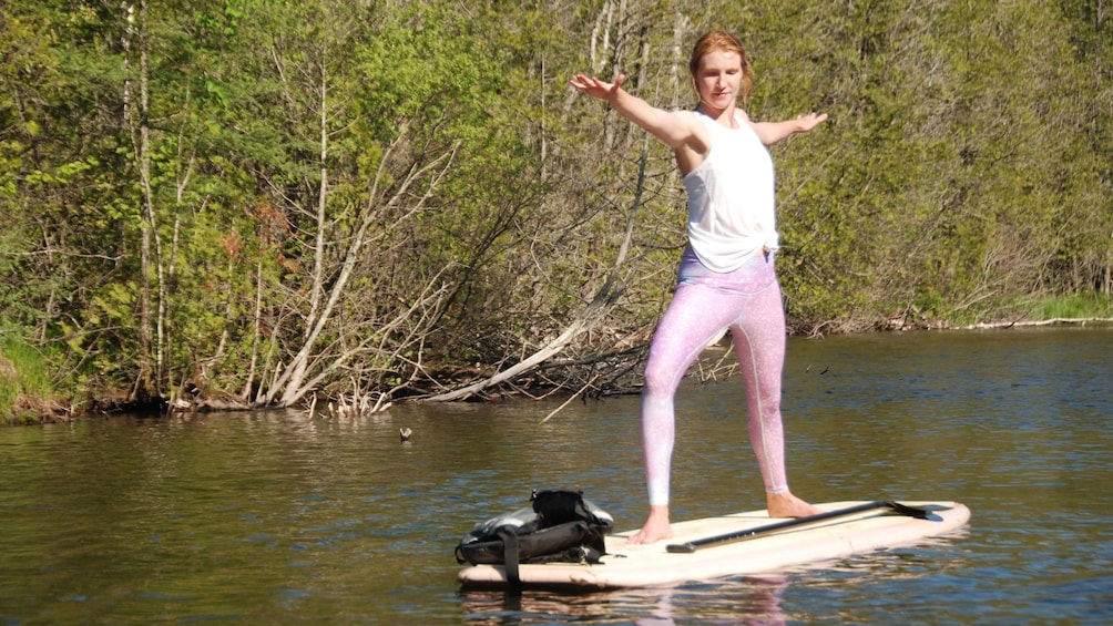 Woman doing yoga on paddle board in Austin