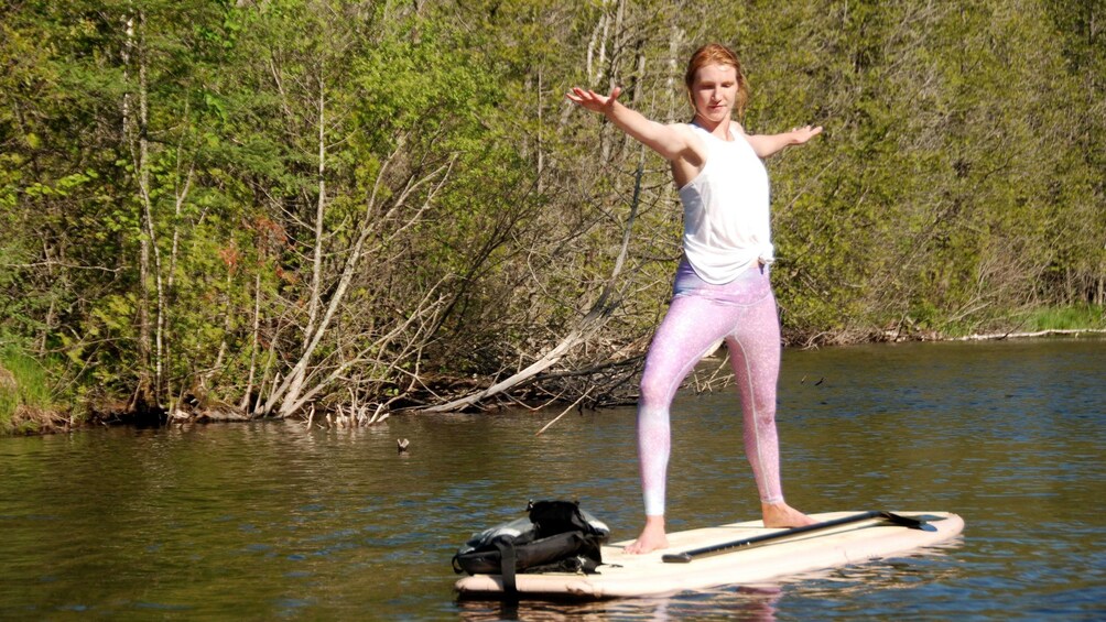 Woman doing yoga on a paddle board in Austin