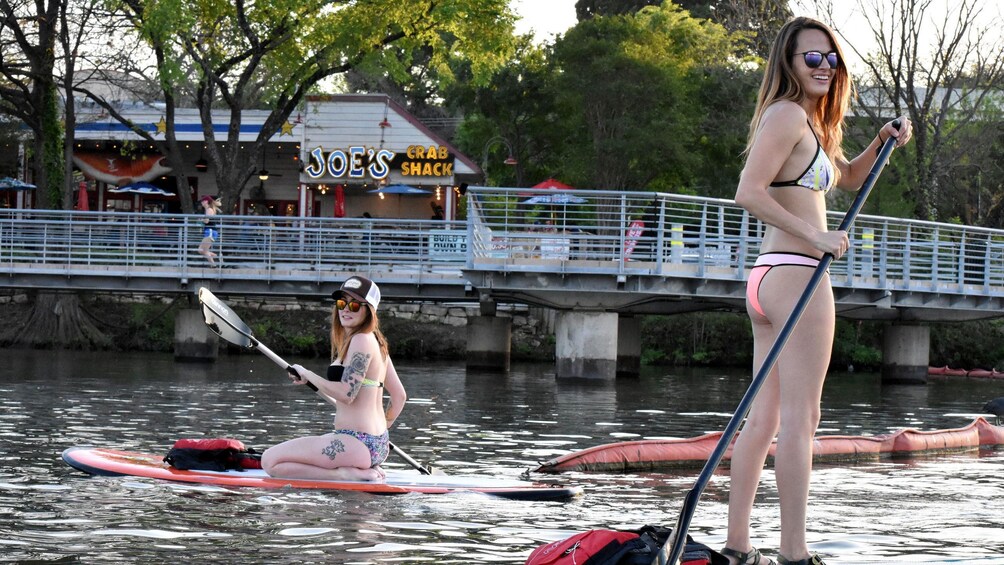 Pair of women on stand-up paddle boards in Austin