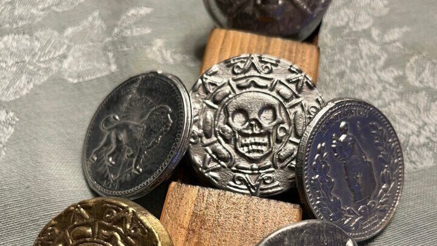 Double sided John Wick continental coin and the Elisabeth Swann Pirates of the Caribbean coin