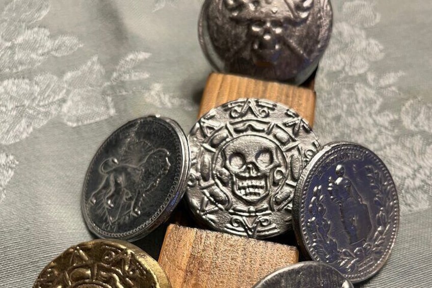 Double sided John Wick continental coin and the Elisabeth Swann Pirates of the Caribbean coin