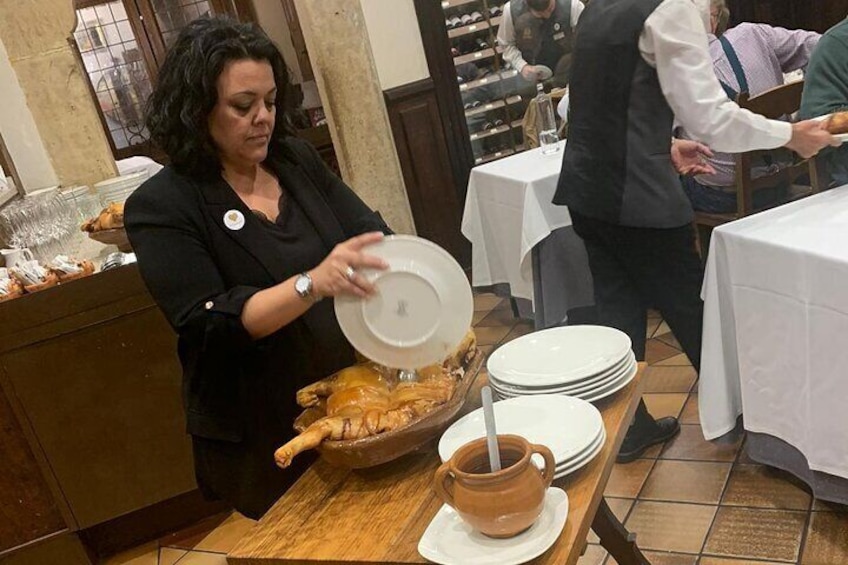 Old tradition of cutting the pig with the plate
