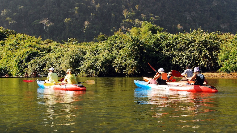 Kayakers paddling down Nam Khan River in Laos