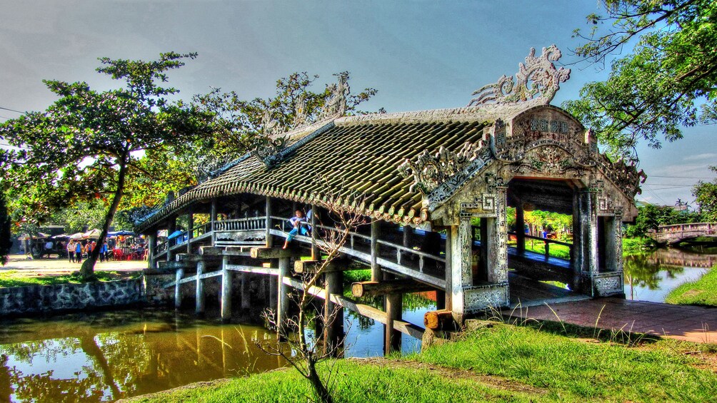 Covered bridge with extravagant roof in Laos
