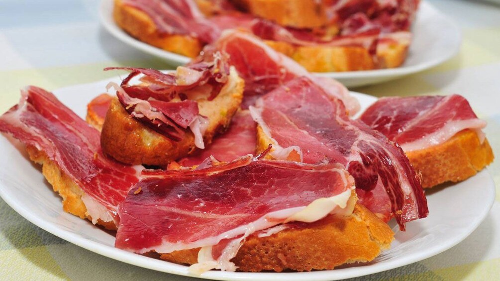 Show item 5 of 6. Bread and sliced meat cuisine in Seville