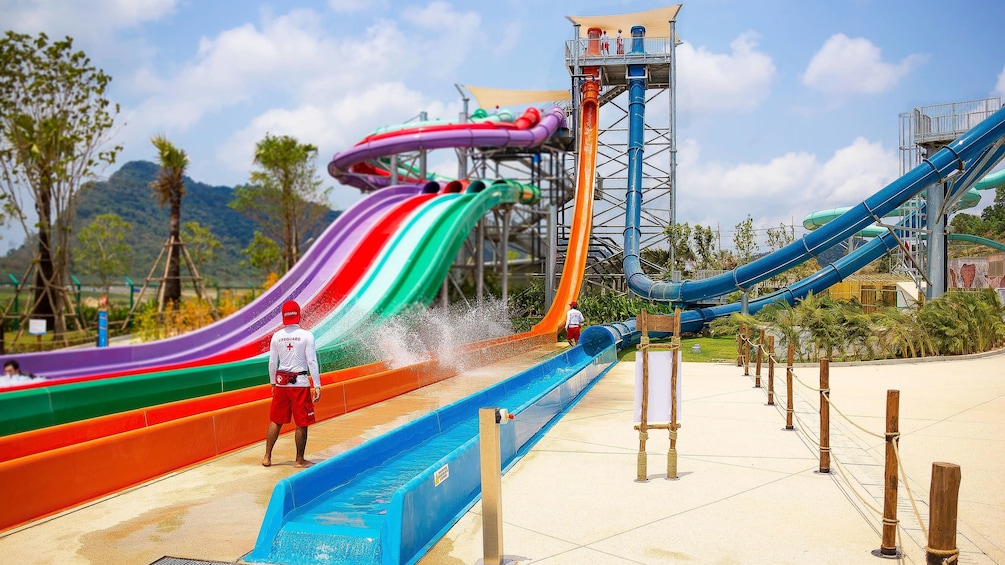 Lifeguards stand near large water slides at Ramayana Water Park in Bangkok