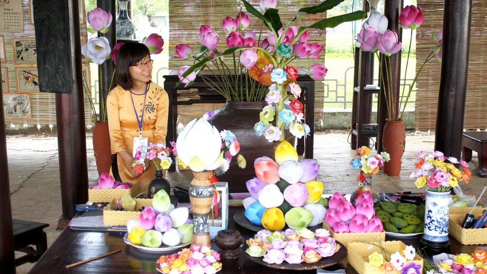 Tour guide with display of flowers during tour in Hue