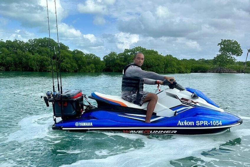 Out Jetski fishing setup, rod holders, a gaff and a stocked cooler