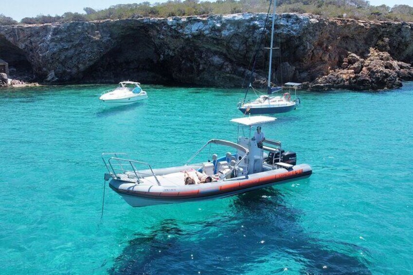 Our fast boat stops at Cala Comte for swimming or snorkeling