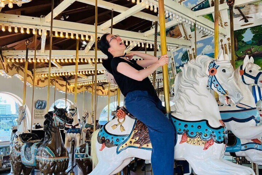 Enjoying a fun ride on the carousel included on our tour!