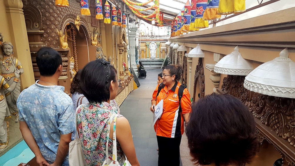 Tour group with guide in temple in Singapore