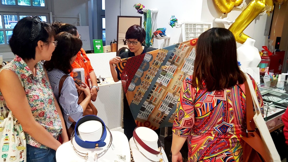 Tour group looking at textiles while on tour in Singapore