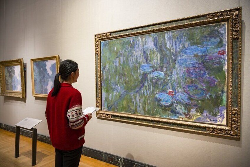 Visitors in the Monet gallery at the Museum of Fine Arts, Boston, viewing Monet's Water Lilies, Reflections of Weeping Willows, on loan from a private collection.