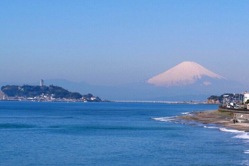 Majestic, snow-capped Mt. Fuji & Enoshima Island seen from Cape Inamuragasaki. 