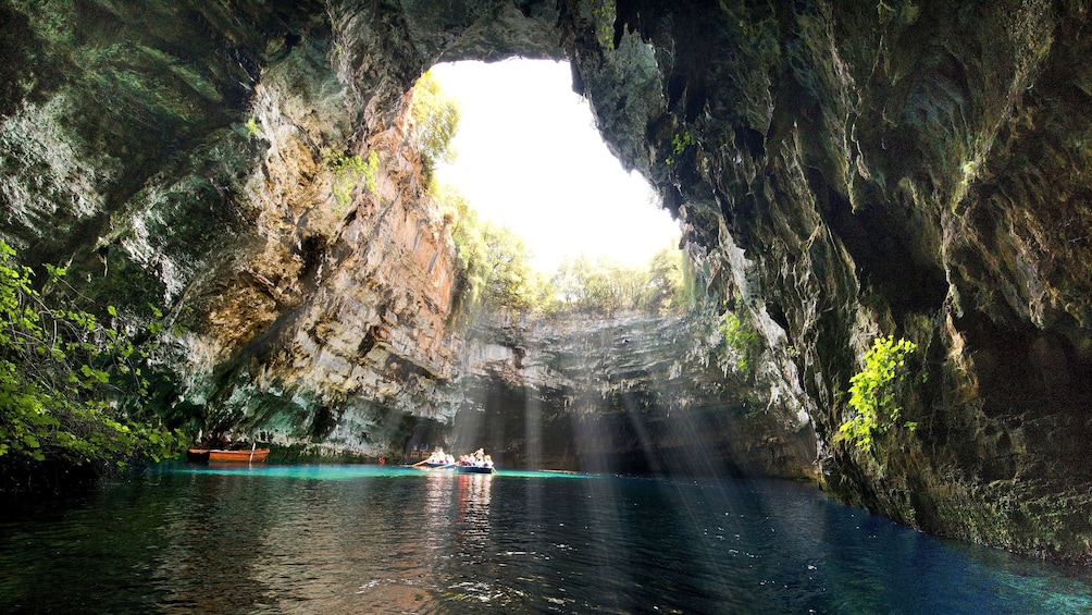 Sun shining inside of cave with Melissani Lake in the Ionian Islands