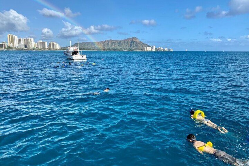 Snorkeling under a rainbow at an offshore reef