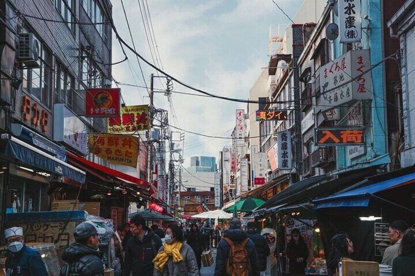 Tsukiji Fish Market, Tokyo's renowned seafood hub, captivates visitors with its bustling atmosphere and diverse array of fresh seafood, making it a culinary haven.