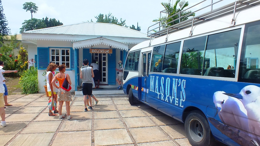 Show item 3 of 5. Tour bus stopped at boutique on Mahe Island