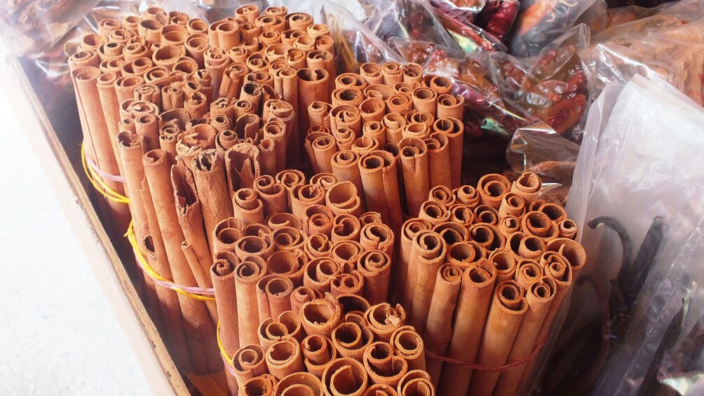 Show item 5 of 5. Bundles of cinnamon sticks in market in Mahe Island