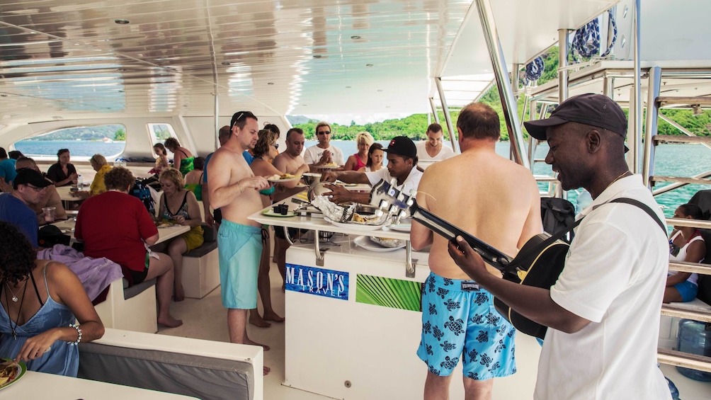 Show item 3 of 5. Entertainment aboard the boat for the Full Day Reef Safari in Seychelles