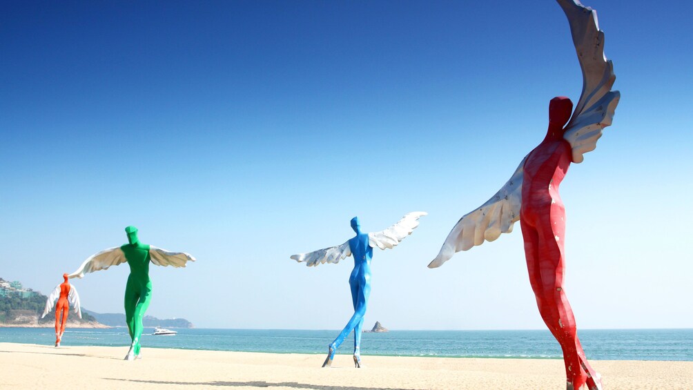 Show item 1 of 5. Large birdman sculptures on beach in Shenzhen