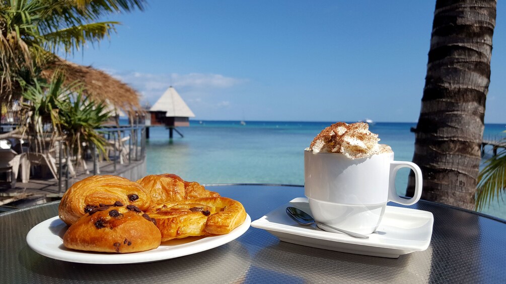 Pastries and coffee at a seaside cafe in New Caledonia