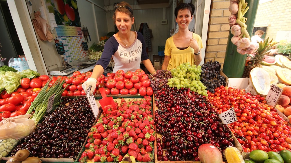 Show item 1 of 10. Vendors at a fruit market in Warsaw