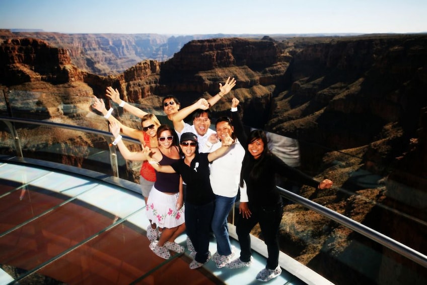 Tourists stand on the West rim of the Grand Canyon