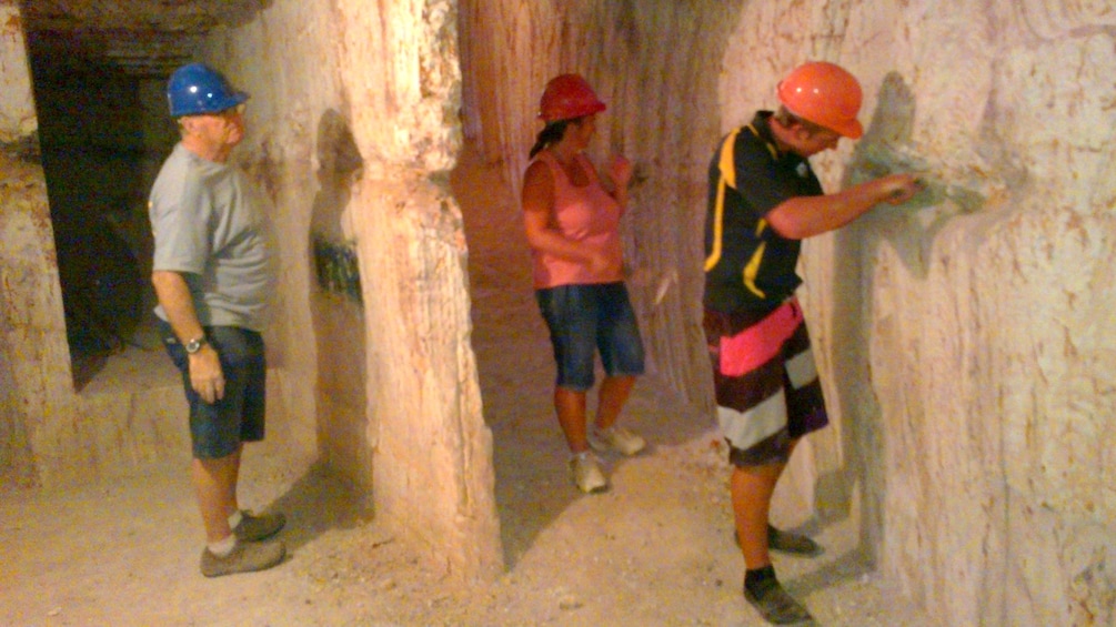 Show item 3 of 4. Group tours a cave in Adelaide