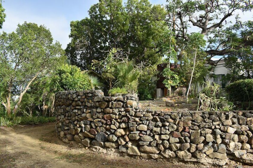 Old French water pipes show on the wall and walking through back north side of property where family cemetery with few of family members and Rachel Levin, a mother of Alexander Hamilton was buried.