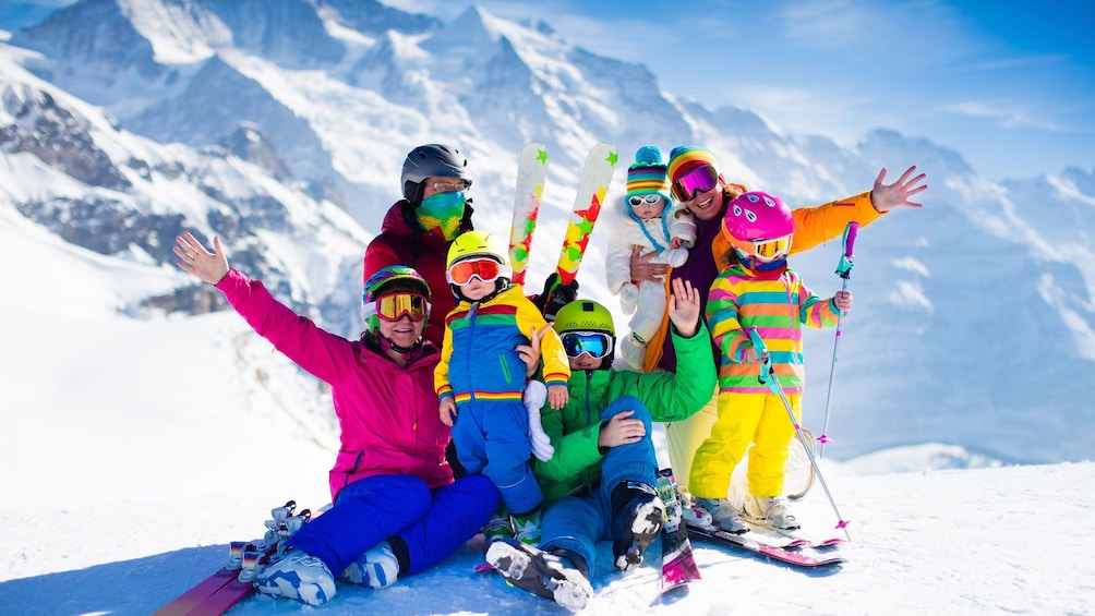 Show item 3 of 4. Group of brightly dressed skiers on slopes of Mammoth mountain in California
