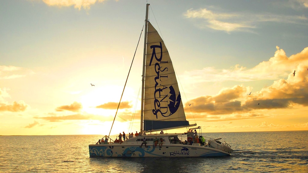 Catamaran sails in the Caribbean at sunset