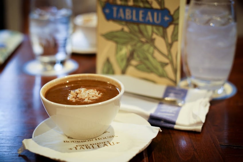 Drinks and food at restaurant on food history tour in New Orleans