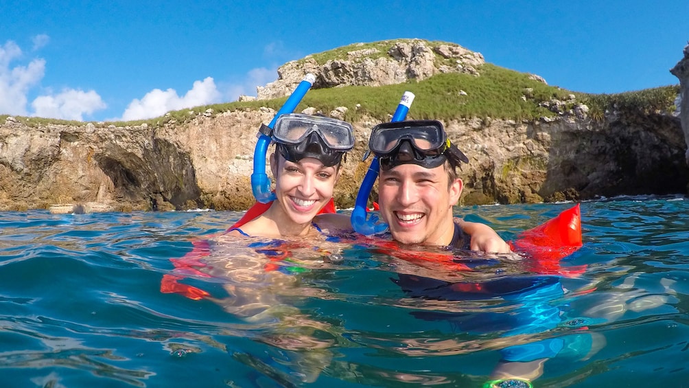 Couple snorkeling  on an island outside Nayarit, Mexico