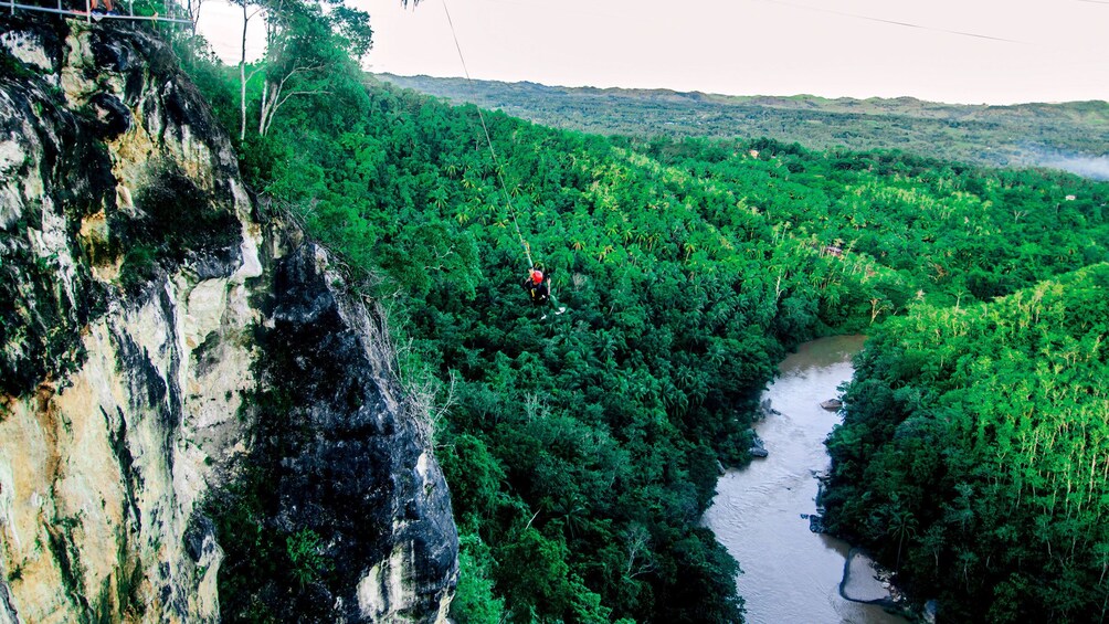 Person bungee jumping over cliff in Danao Adventure Park