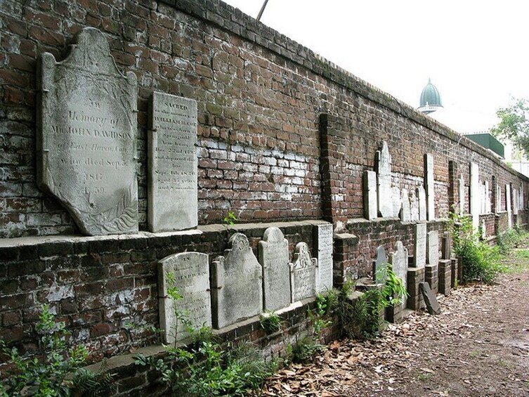 Show item 1 of 2. Stone wall with grave markers in Savannah