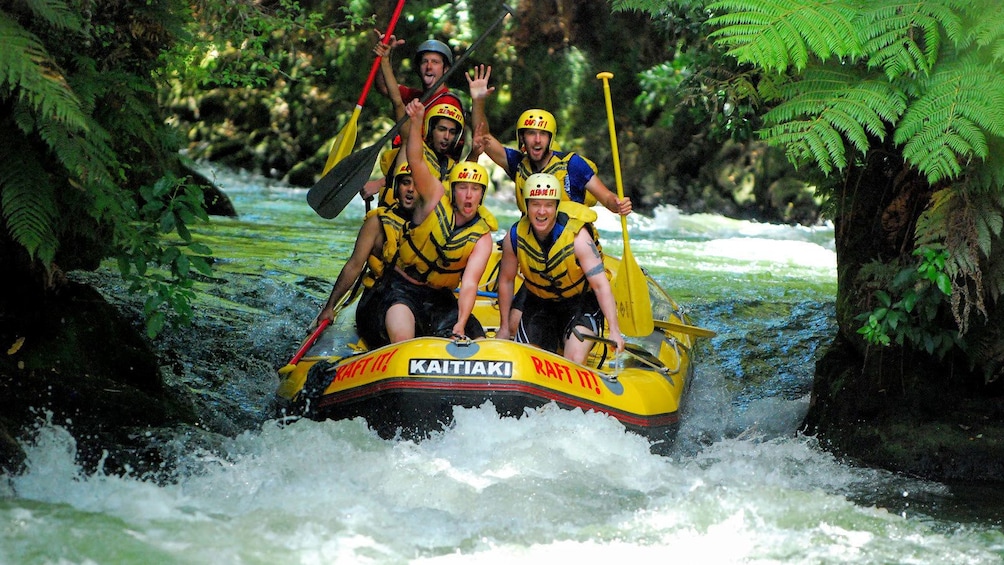 White water rafting group going down a river in Krabi