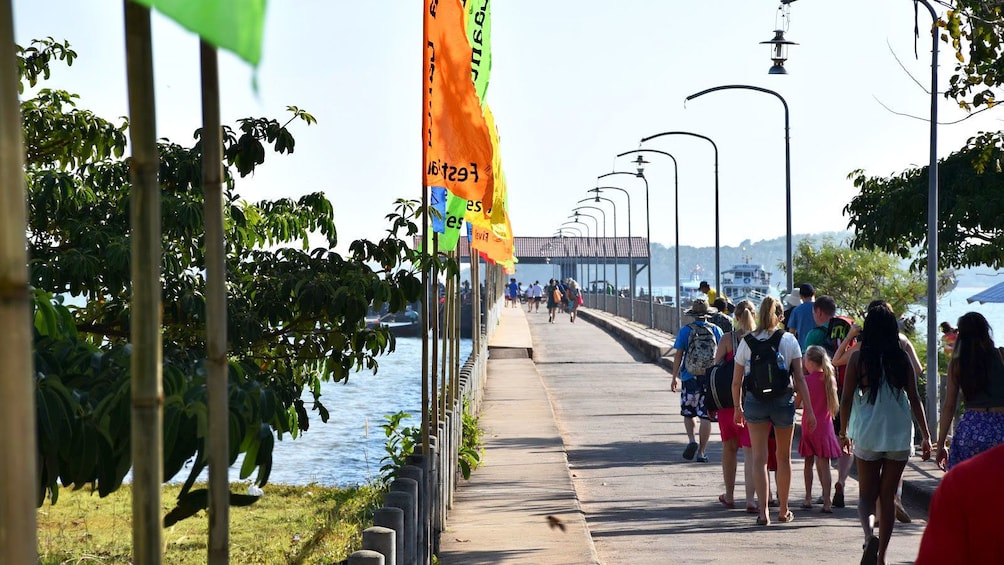 People walking down pier for boat in Koh Lanta