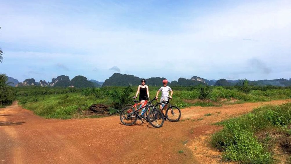 Couple Eco Cycling through Green Krabi