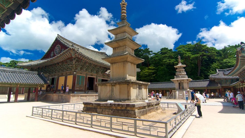 Large monument amongst historical buildings in Gyeongju