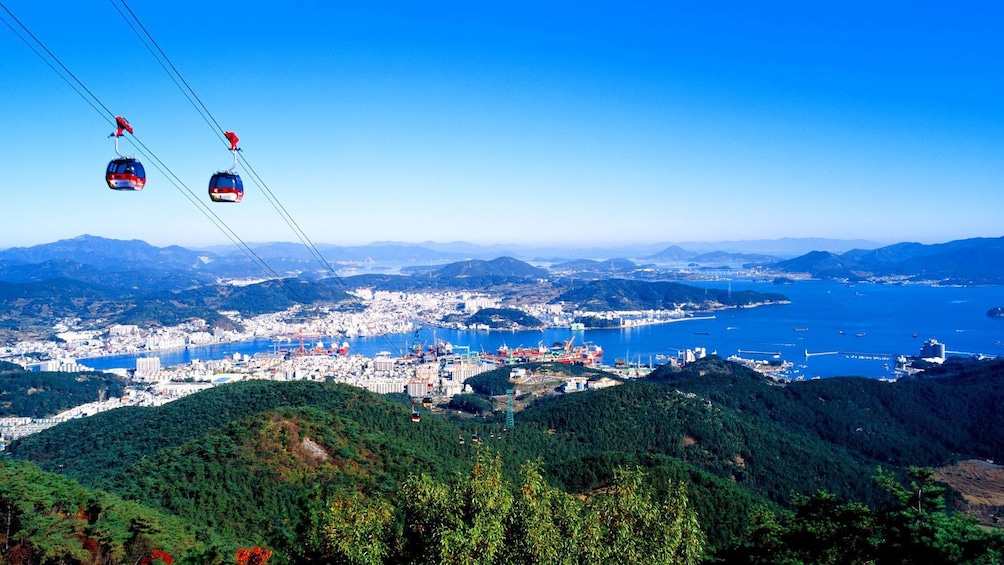 Gondolas ascending and descending from mountain outside of Tongyeong