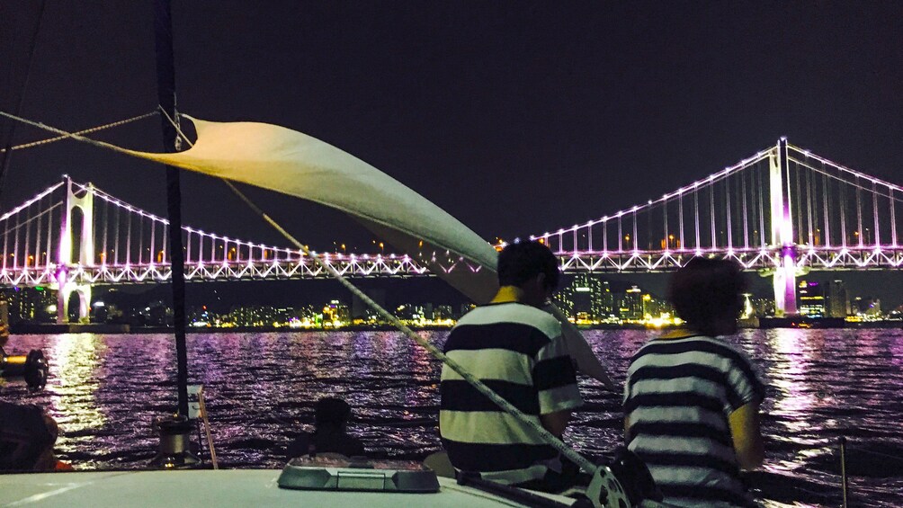 Two people on a yacht at night in Busan, South Korea at night