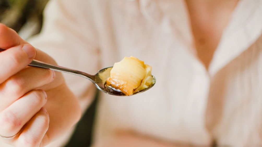 Woman with spoon of food on a tour in San Juan, Puerto Rico