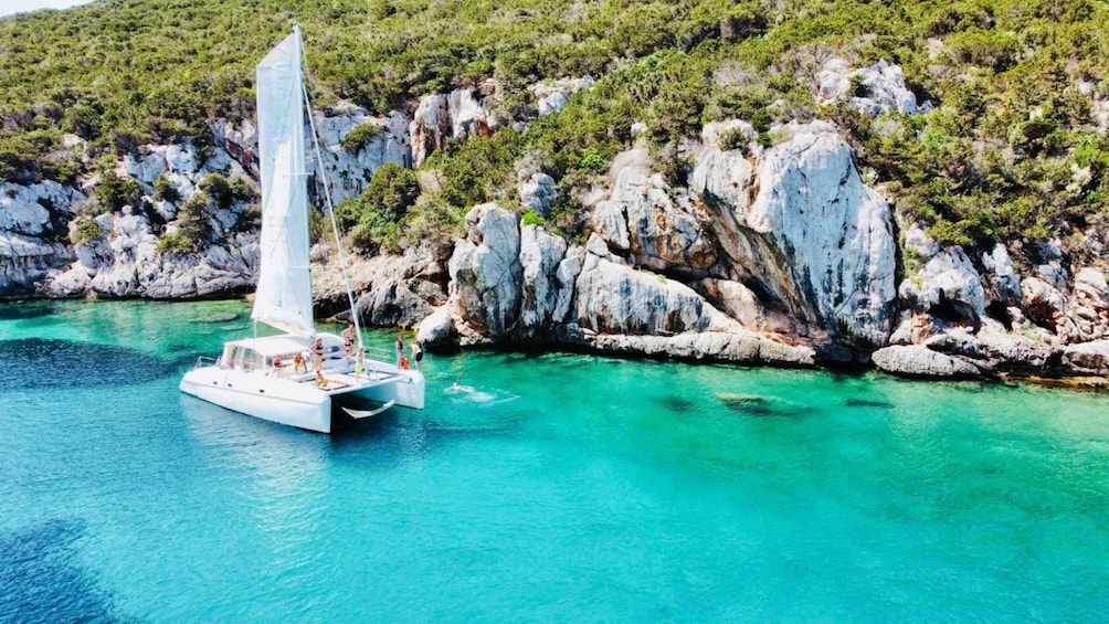 Alghero: Full day on a catamaran in Porto Conte Natural Park