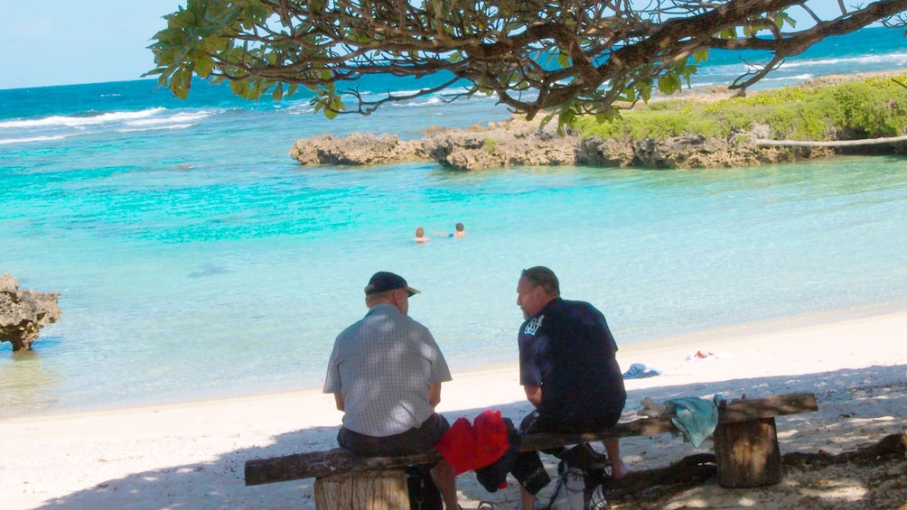 Two men sitting on a beach on Vanuatu Island