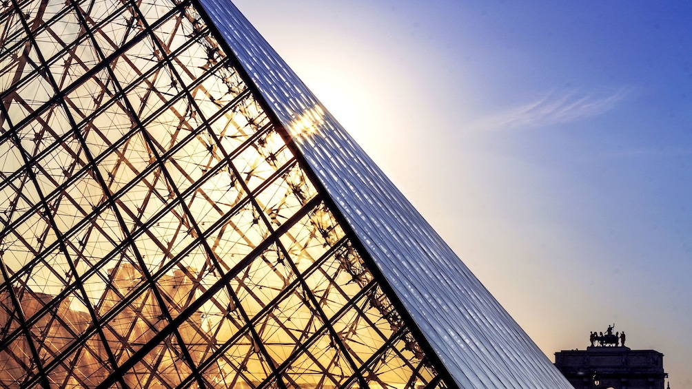 Sun shining through the pyramid of the Louvre